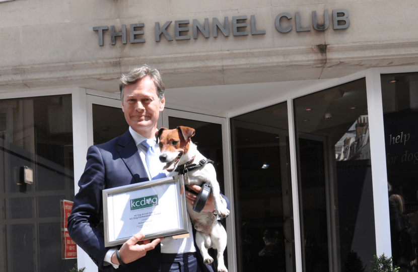 Matthew and Max receiving a reward from the Kennel Club