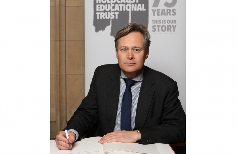 Matthew Offord MP signing the Holocaust Memorial Trust book in Parliament