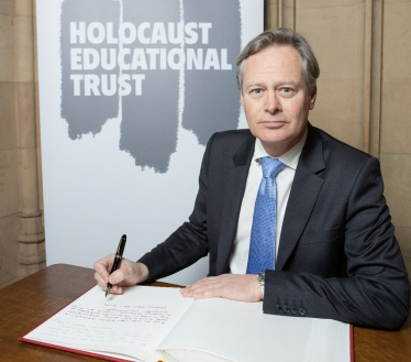 Matthew Offord MP signing the Holocaust Memorial Day book of commitment 