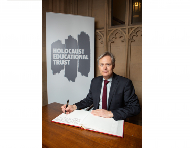 Matthew signing the Holocaust Educational Trust's Book of Commitment in Parliament. 